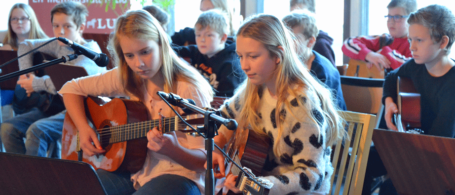 Två tjejer som spelar gitarr och sjunger